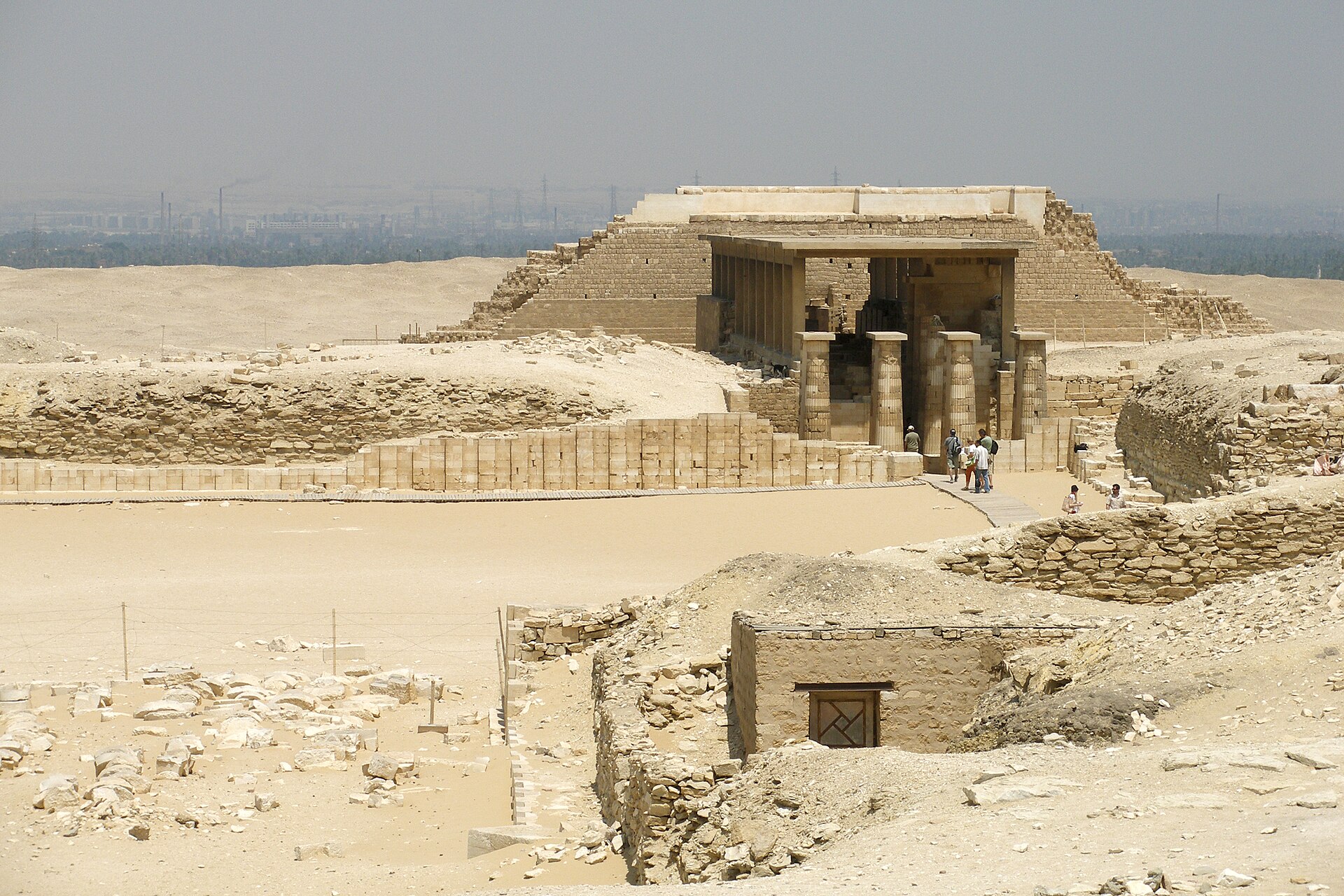 Desert landscape of the Saqqara necropolis with ancient ruins and pyramids